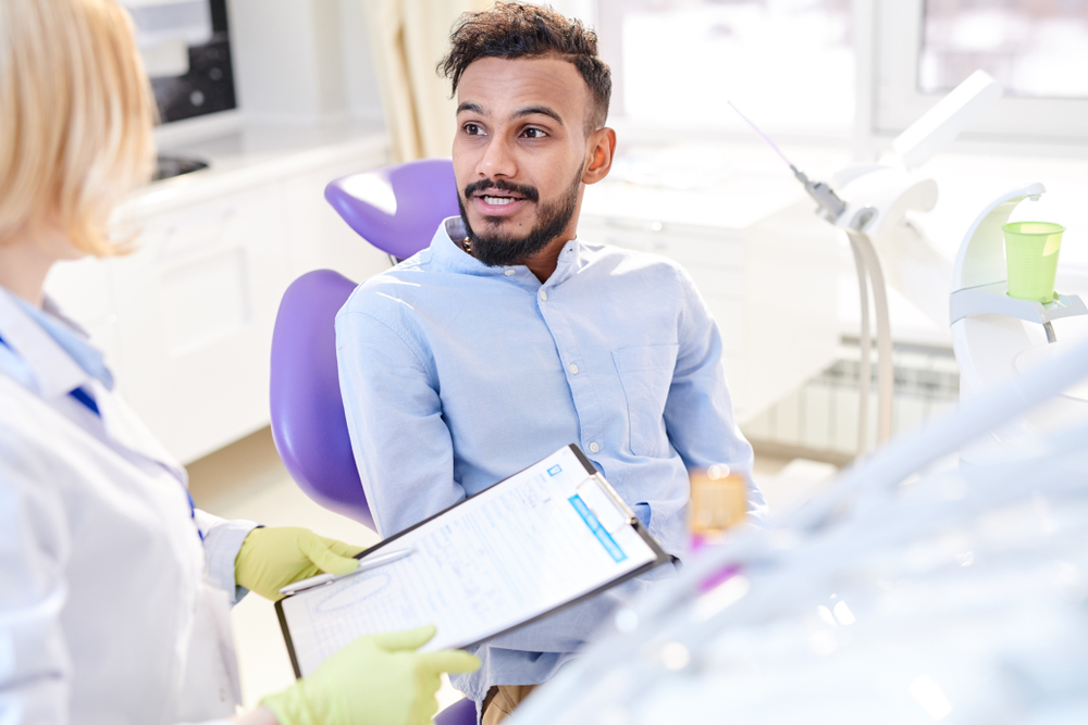 shutterstock 1079563379 man talking to dentist