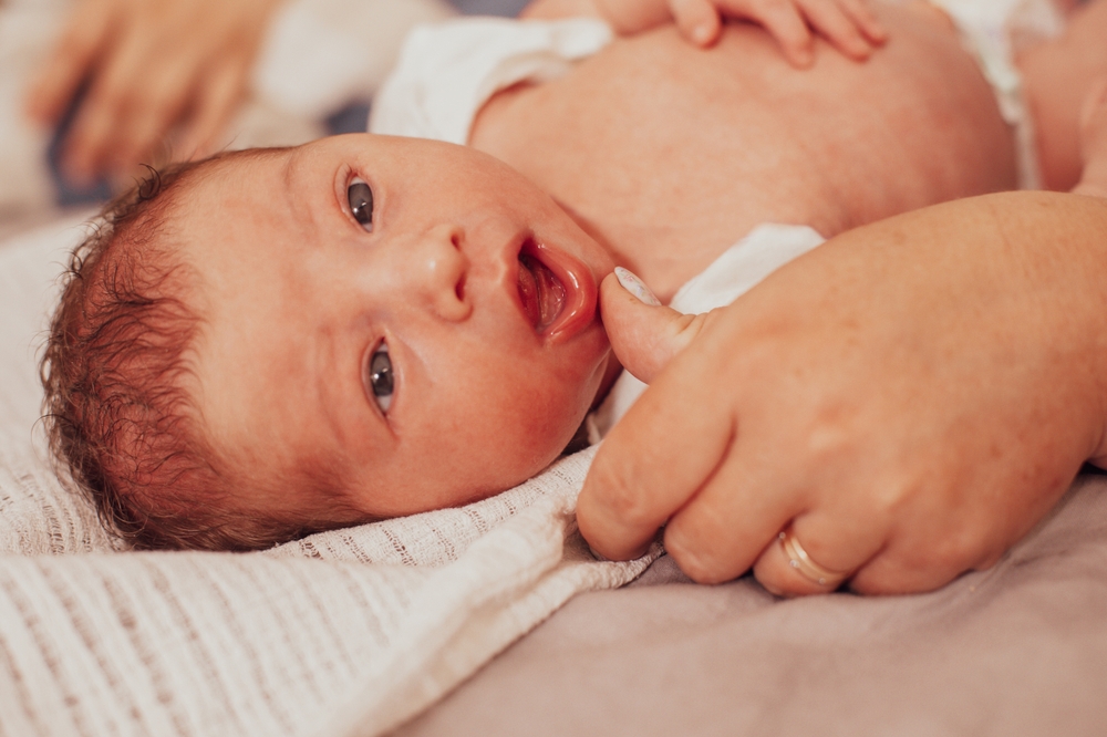 shutterstock 2375622921 checking baby for tongue and lip ties
