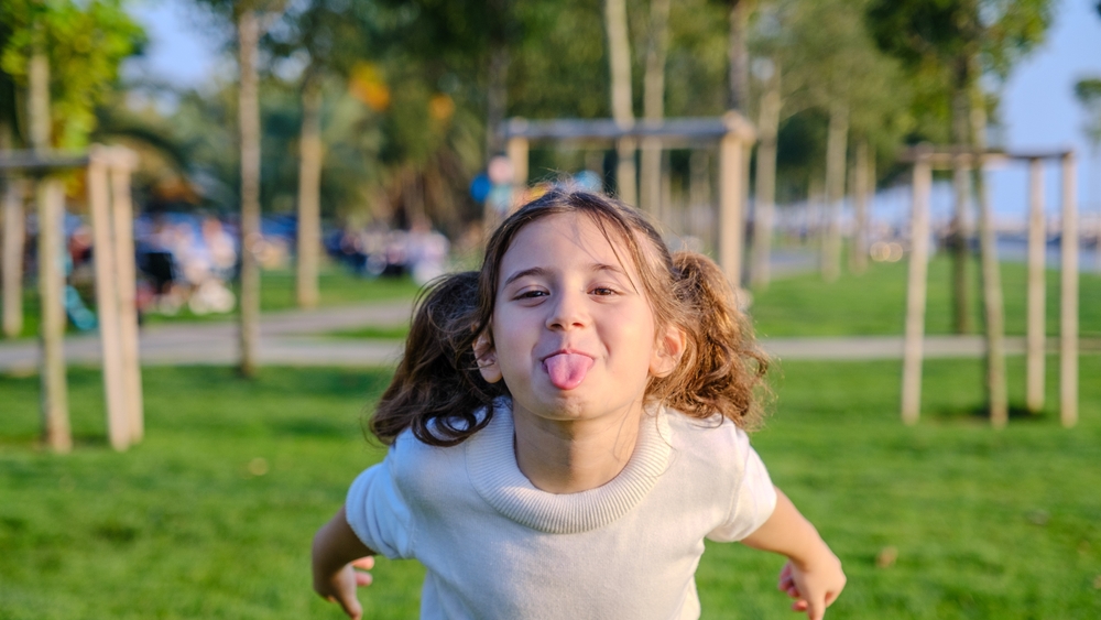 young girl sticking out her tongue