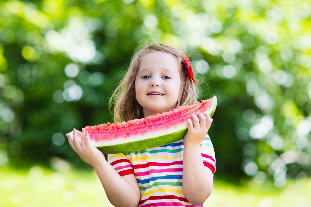 child eating watermelon